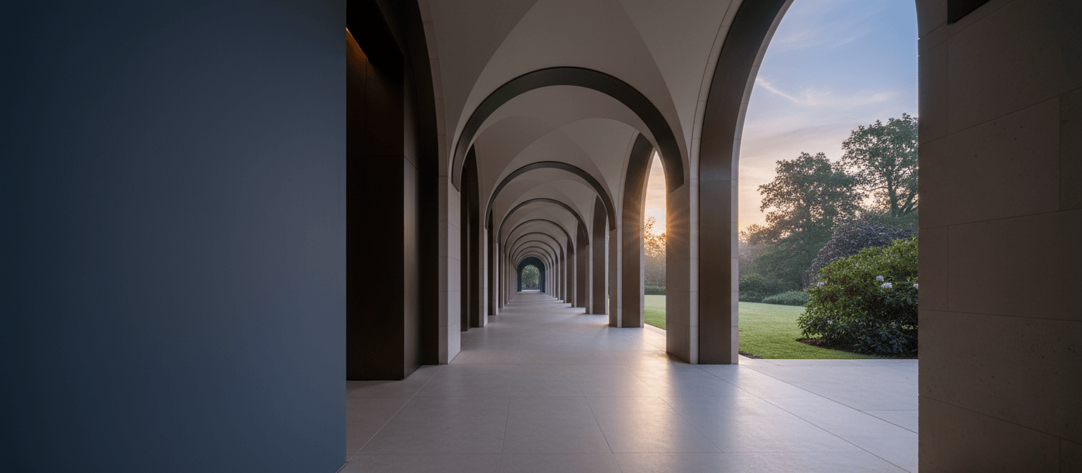 Colonnaded arcade in centered perspective: cream arches converge to a golden starburst; lawn and pink shrubs visible through right openings.
